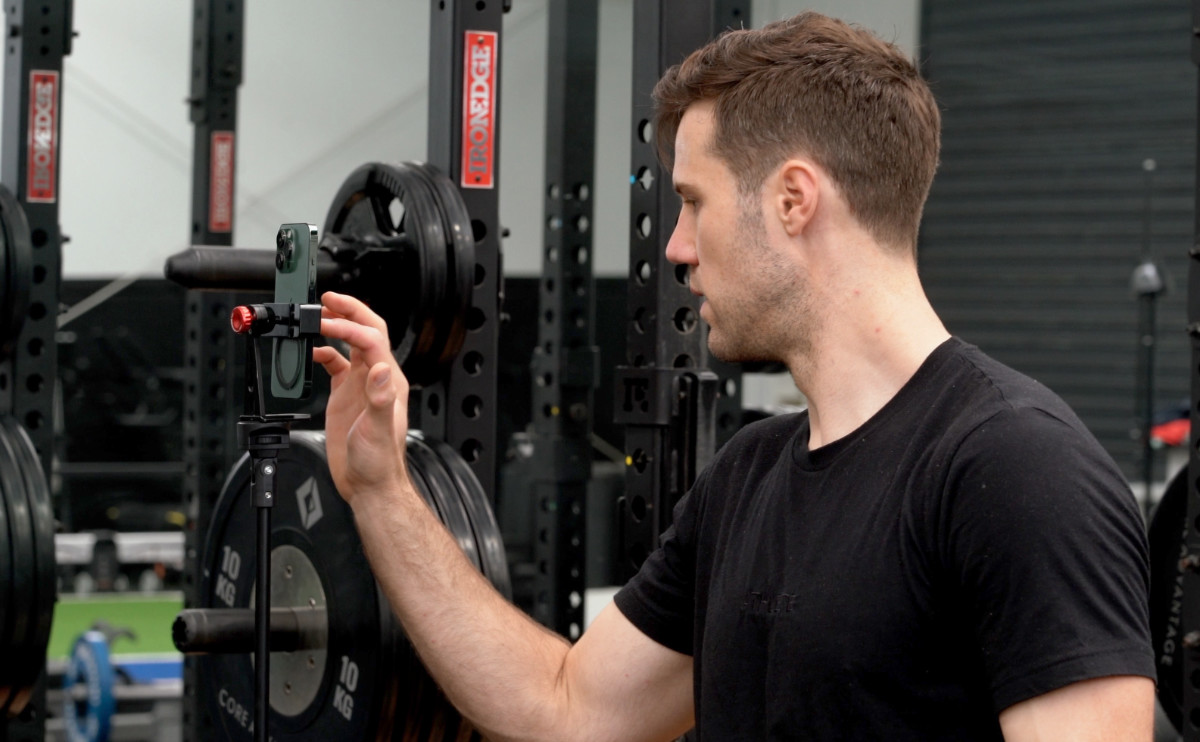 Athlete using velocity based training on the Metric VBT app and in a Tripod